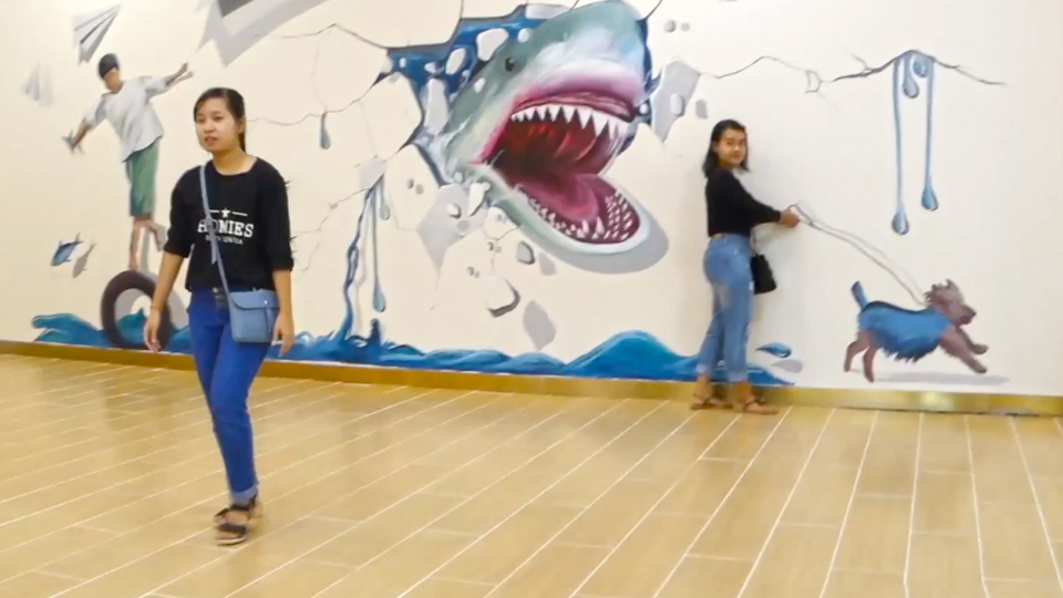 Girl posing at Ocean Shwe Gone Daing wall shark mural